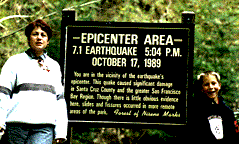 woman and child in front of sign commemorating 1989 earthquake